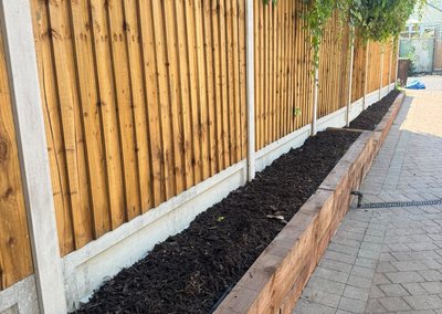 Closeboard fence panels with a sleeper raised bed