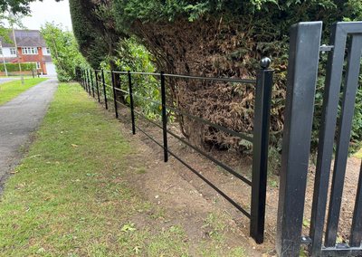 Black estate railings and gate post